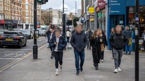 People walking through a busy UK street with their faces automatically blurred by BlurMe's AI anonymisation platform.