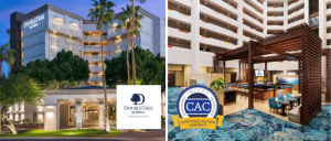Exterior view of DoubleTree by Hilton Phoenix Mesa hotel and its lobby with a Certified Autism Center badge.