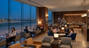 A spacious, high-end airport lounge interior illuminated by warm lighting during twilight with business travelers sit on plush leather armchairs and contemporary seating, some working on laptops and others chatting.