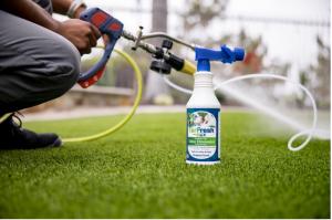 TurFresh technician applying BioX artificial grass odor eliminator during a professional synthetic turf cleaning service in Phoenix, Arizona.