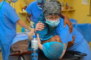 A Shekinah Global Volunteer Clinician comforts a patient during the January 2026 mission in Abeokuta, Nigeria.