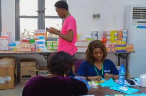 Volunteer Clinicians sort and dispense medication at the mission pharmacy station.