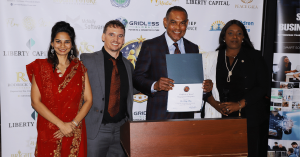 Dr. Rudolph Moise receiving a National Parents Day 2026 award at the Wealth Strategy Media and Relief Alliance celebration, recognizing leadership, community service, and commitment to families.