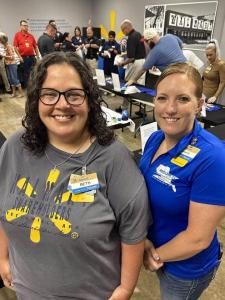 Walmart associates, Springfield police officers, and local councilmembers assembling emergency trauma kits for children at a community event.