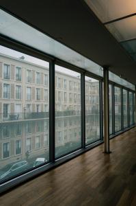 Floor-to-ceiling commercial window installation in a modern hallway overlooking an urban courtyard by Summit Valley Glass & Window.