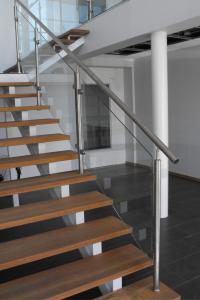 Custom interior glass stair railing with stainless steel hardware and wooden floating stairs installed by Summit Valley Glass & Window.