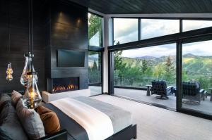 Luxury bedroom featuring large sliding glass doors and custom mountain-view windows installed by Summit Valley Glass & Window.