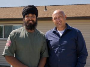 Upfront Septic and Plumbing Business Partners Harman Kaler and David White stand in front of a Pierce County home