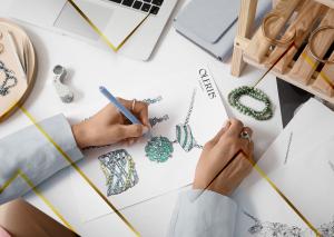 Jewelry designer sketching a custom High Jewelry necklace concept for Olertis' national jewelry design contest supporting charitable organizations in the United States.