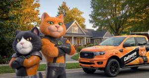 Catseye Pest Control mascots standing beside a branded orange service truck outside a home.
