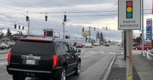 Car approaching a red light with the photo enforced sign evident