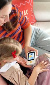 Adult and child using a white Dr.Look Ai Learning Camera together at home.