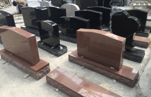 Polished black and red granite headstone components prepared for inspection and customization.