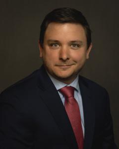 A professional image of Adam Roland, vice president of outpatient services for OneQuest Health