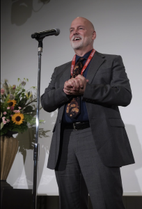 Man in suit at Osaka Japan celebration for 20th year anniversary of Asterisk
