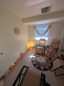 Salt relaxation room at Doc Hypnosis Wellness Center in Phoenix with reclining chairs, illuminated salt bricks, warm lighting, and a lotus rug.