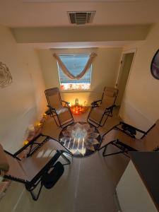 Salt relaxation room at Doc Hypnosis Wellness Center in Phoenix with four reclining chairs, illuminated salt bricks, warm ambient lighting, and a lotus-pattern rug.