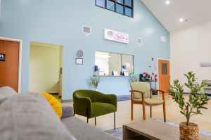 Interior lobby with seating area and glass window for receptionist