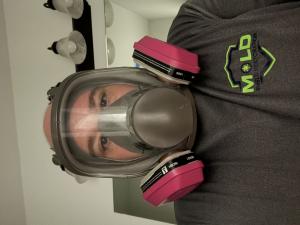 Ron Prevost wearing professional respiratory protections while demonstrating proper mold remediation safety practices in Louisiana