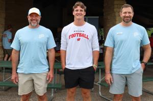 UW quarterback Colton Joseph with attorneys William Pemberton and Rhyan Lindley