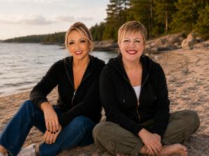 The Sixth co-founders Fay Chapple and Stacy Maynard sitting together on a Georgian Bay beach