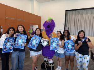 Photo of Tower Buzzers mascot, Hollywood, with girls participating in the Girls Inc. outreach event.