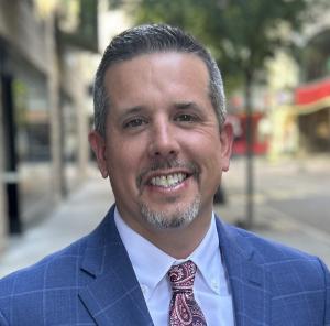 Headshot of Ascendient CEO Brian Ackerman in a blue sport coat