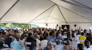 Sant Rajinder Singh Ji Maharaj delivers the inauguration address under a tent to a large gathering at the new Science of Spirituality Meditation Center in Lynnwood, Washington