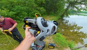 Search volunteers deploy a CHASING M2 S underwater ROV from the reservoir shoreline.