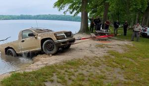Recovery teams remove the confirmed submerged vehicle from Deer Creek Reservoir after underwater identification.