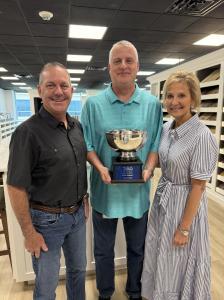 Mike Feigin, Chad Ballard, and Barbara Feigin of Design Tech Homes pose with the W.R. Coleman Award for Best in Show, presented during the 2026 Texas Institute of Building Design Design Competition.