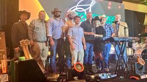 Team members of Priority Signs & Graphics pose on stage after receiving the 2026 Southlake Small Business of the Year award.