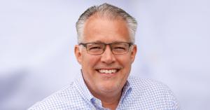 Dan Price, founder of Oink Ink Radio and BionicVO, smiling in a professional headshot.