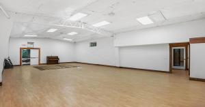 Interior of the gymnasium at Redemption Canyon, an open room with wood flooring and high ceilings.