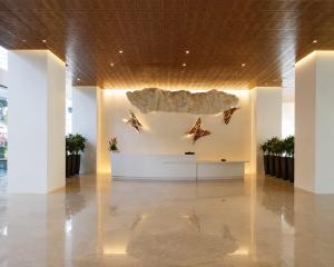 Premium acrylic solid surface reception desk in a modern commercial lobby showcasing seamless architectural design for hospitality and commercial interiors.