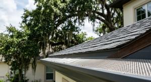 Close-up of a metal gutter on a roof, showcasing the gutter guard designed to prevent debris accumulation.
