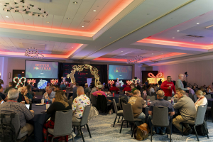 conference room staged with round tables surrounded by lighted christmas decorations