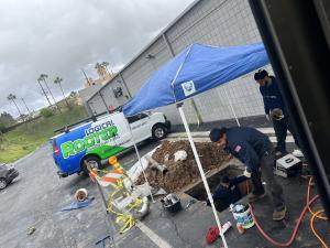 Image of Logical Rooter Drain Cleaning Team Replacing a Pipe in a parking lot in Los Angeles.