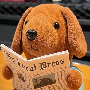 The My Local Press Mascot Choco the Doxin Puppy Reading the News Paper