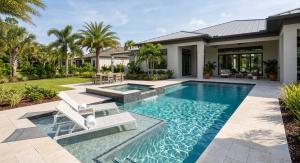 A residential pool area featuring a sparkling pool and comfortable lounge chairs, set against the backdrop of a house.