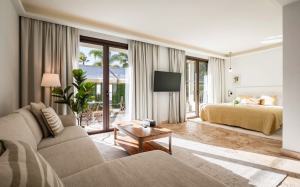 Bright, comfortably furnished ensuite living room at Oasis Premium Recovery's residential addiction treatment center in Spain, with seating area and natural light.