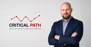 Brett Coakley, founder of Critical Path, a Raleigh fractional COO and executive coaching practice, beside the Critical Path logo