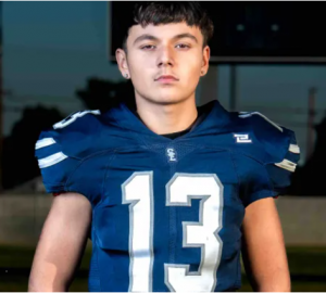 "Portrait of Christopher Garcia wearing his South East High School football uniform with jersey number 13."