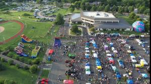 Aerial view of vendor tents, inflatables and crowds at Evesham Township's National Night Out 2026