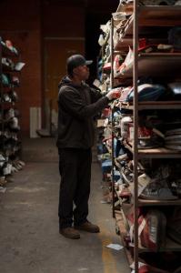 Warehouse aisle with organized used auto parts on shelving at Select Auto Parts & Sales in Milwaukee.