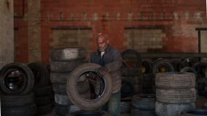 Select Auto Parts employee working among stored tires inside the Milwaukee facility.