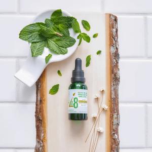 a bottle of tincture oil on a slab of wood