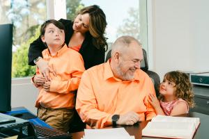 Tax attorney Pietro Canestrelli, founder of the Law Office of Pietro Canestrelli, pictured in his office with his wife and two grandchildren.