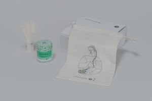 Photo of subscription box of Zenkyu Matcha, containing matcha tin, paper whisk, and original bag.