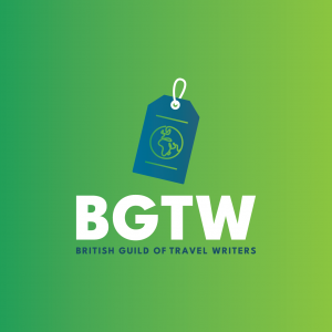 The British Guild of Travel Writers logo on a green gradient background